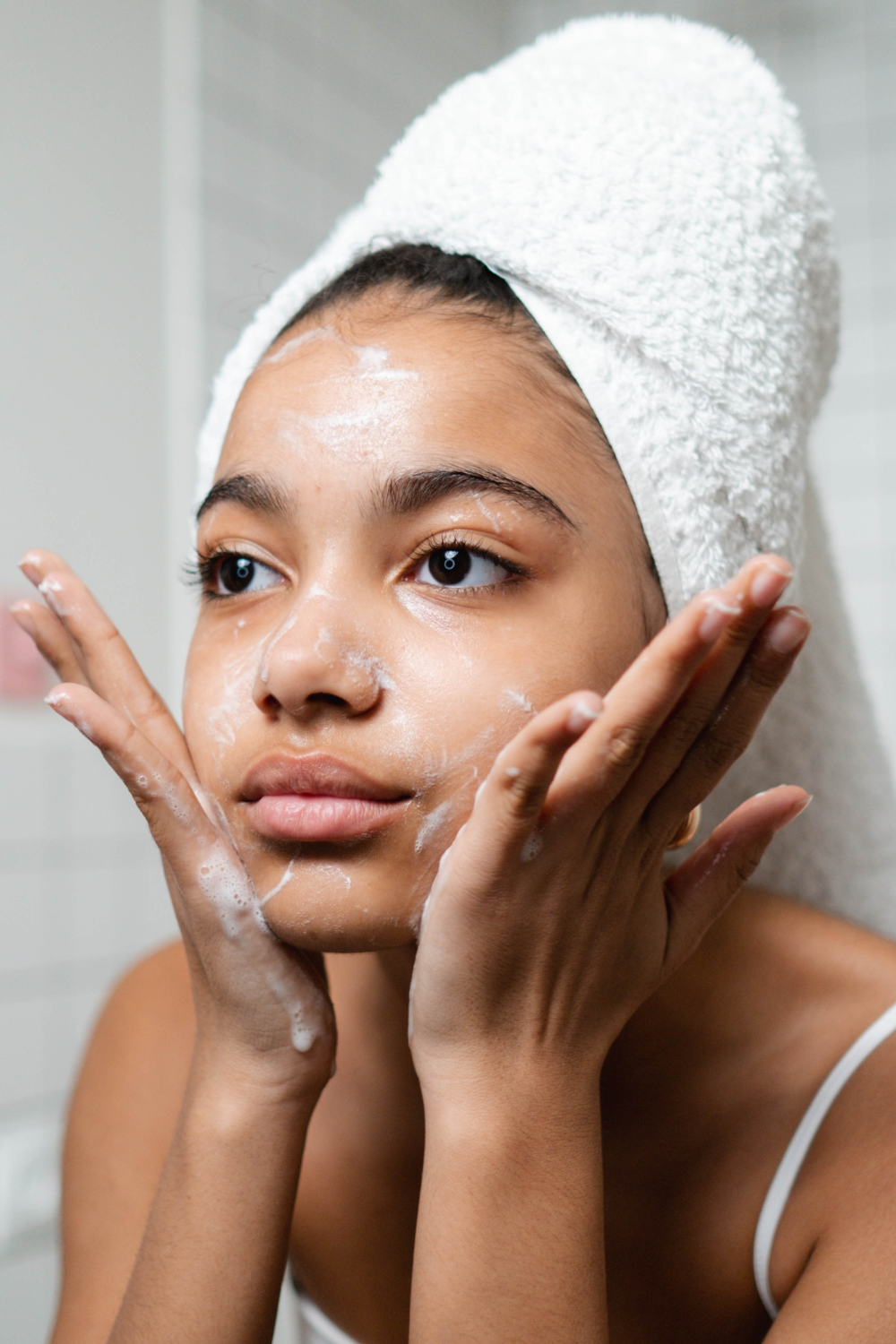 woman putting on skincare products